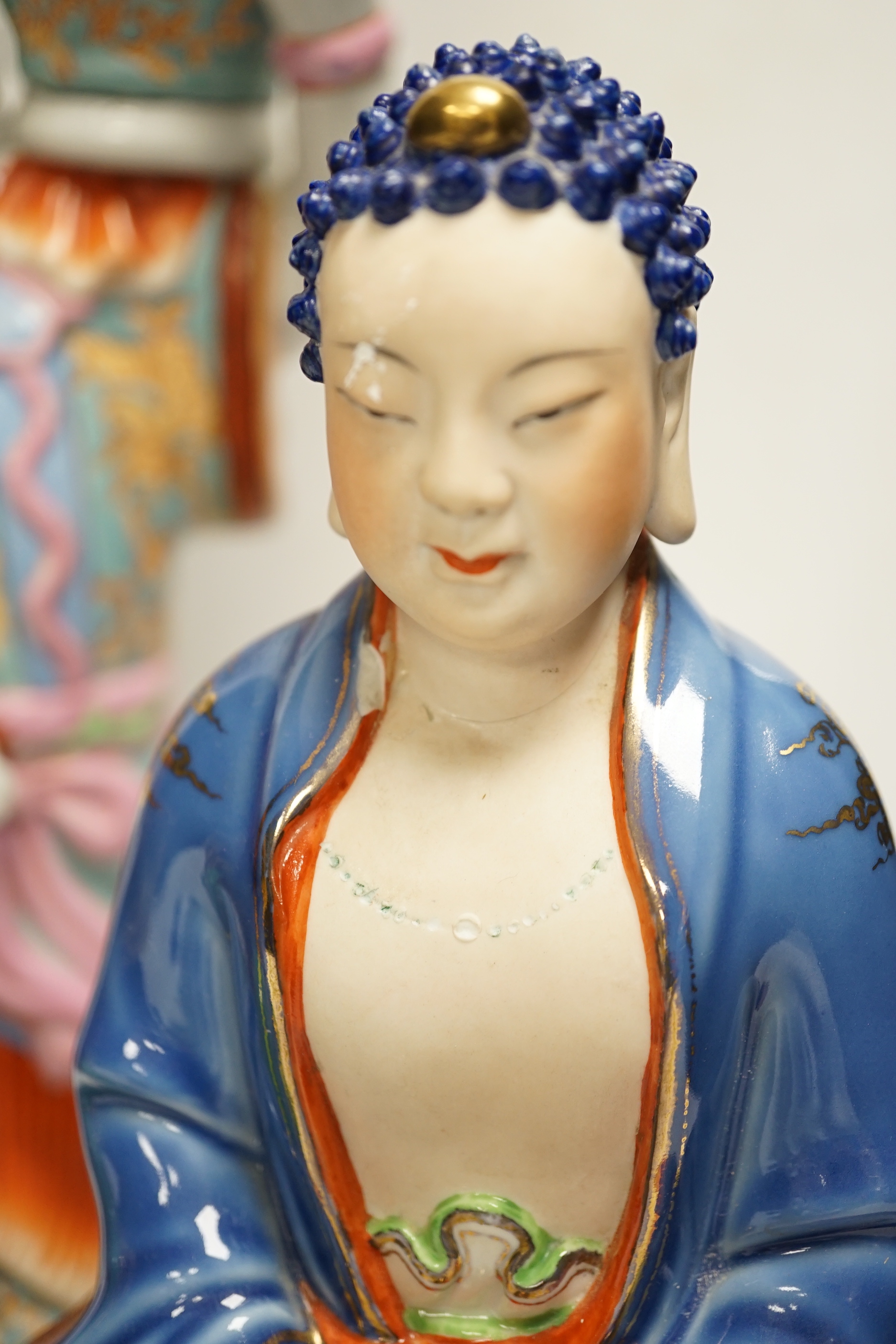 Five Chinese figures of Buddha or Budai, including a hardwood example, largest 38cm high